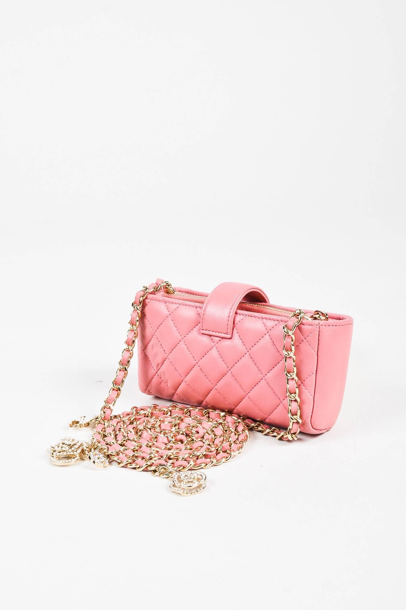 Retails $2200. Carry your most important essentials in this pink mini bag. From Chanel's Spring 2014 Valentine Collection. Constructed of soft and supple quilted lambskin leather. Tab fastening featuring a 'CC' emblem. Chain crossbody strap woven