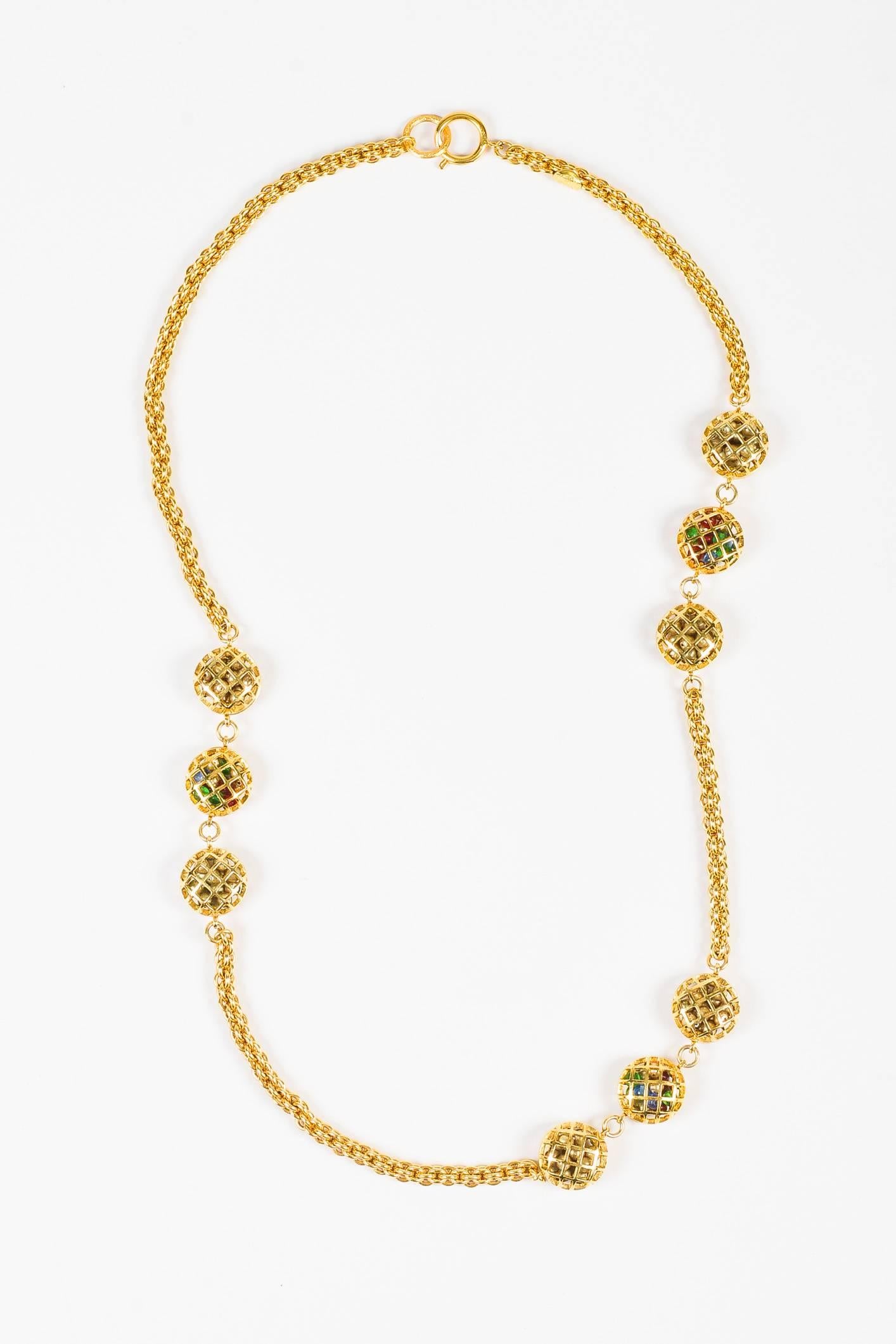 Released circa 1971-1980. Gold-tone chain-link necklace featuring cage stations filled with signature Gripoix stones. Spring ring clasp.

Additional measurements: Chain Width 8mm, Pendant Height: Approx. 1 in, Pendant Length Approx. 1 in, Necklace