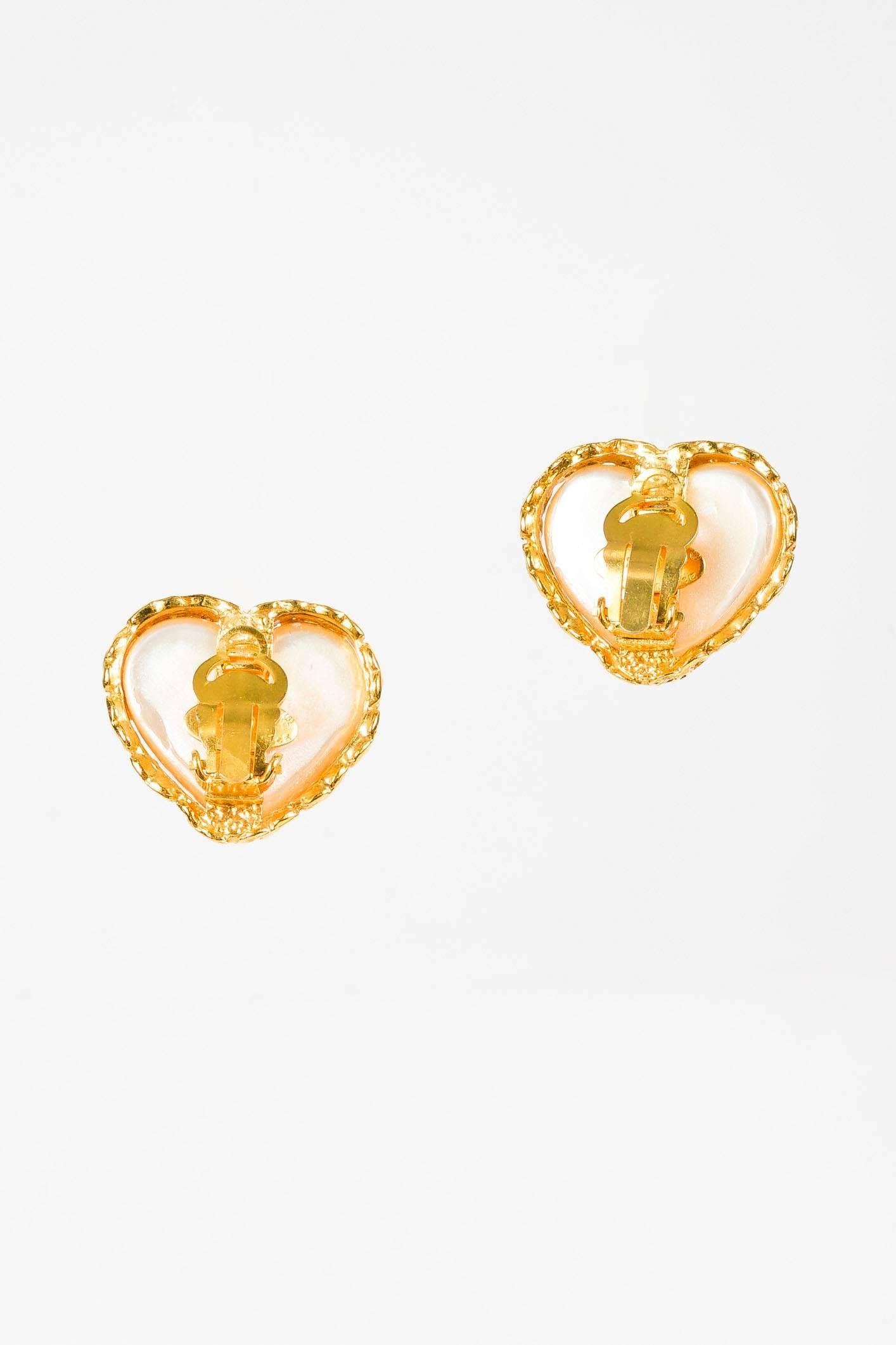Released circa 1991 From season 28.  Faux pearl heart clip-on earring featuring a gold-tone metal 'CC' trim.

Additional measurements: Total Height approx. 1"

Condition details: Pre-owned. This item is in good condition. Chipped coating