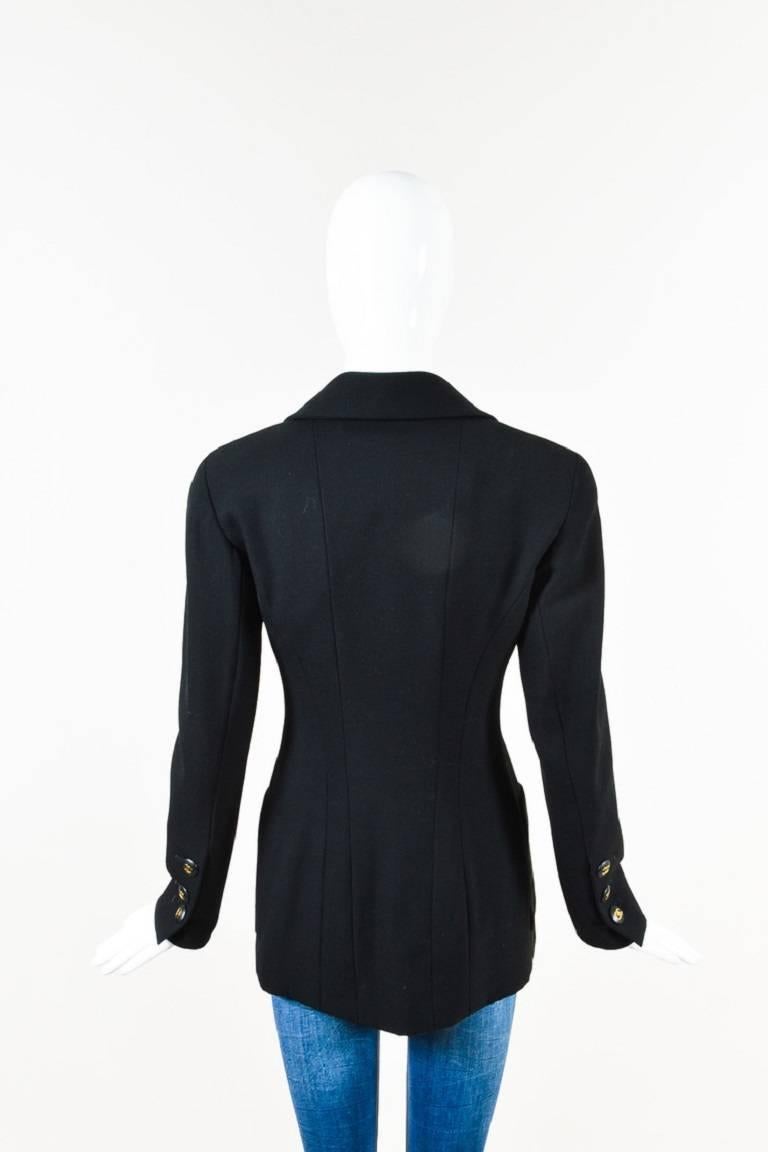 Color: Black,
Made In: France
Fabric Content: Wool; Silk

Item Specifics & Details: Vintage black long double breasted blazer by Chanel Boutique. Oversize lapel, with plunging v-neckline, double chest flat pockets, and double hip flap pockets.