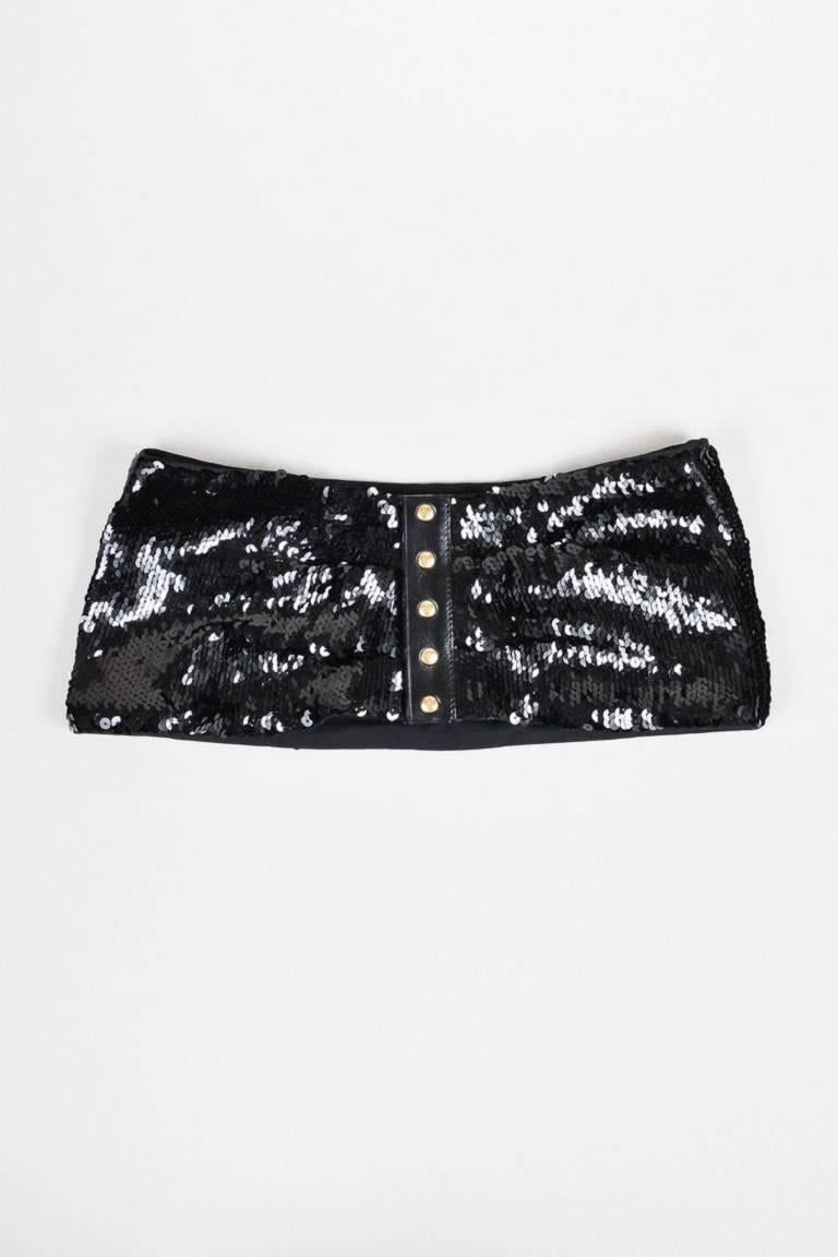 Color: Black,Gold,
Made In: France
Fabric Content: Leather, Synthetic, Metal

Item Specifics & Details: Black sequined wide belt by Louis Vuitton. Features a thin leather panel down front with gold-tone, logo engraved snap button-up closure.