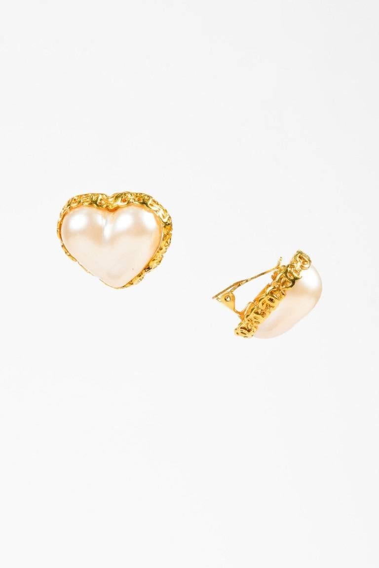 Color: Gold,White,
Made In: France
Fabric Content: Metal, Faux Pearl

Item Specifics & Details: Released circa 1991 From season 28. Faux pearl heart clip-on earring featuring a gold-tone metal 'CC' trim.

Measurements:
Total Height: Approx.