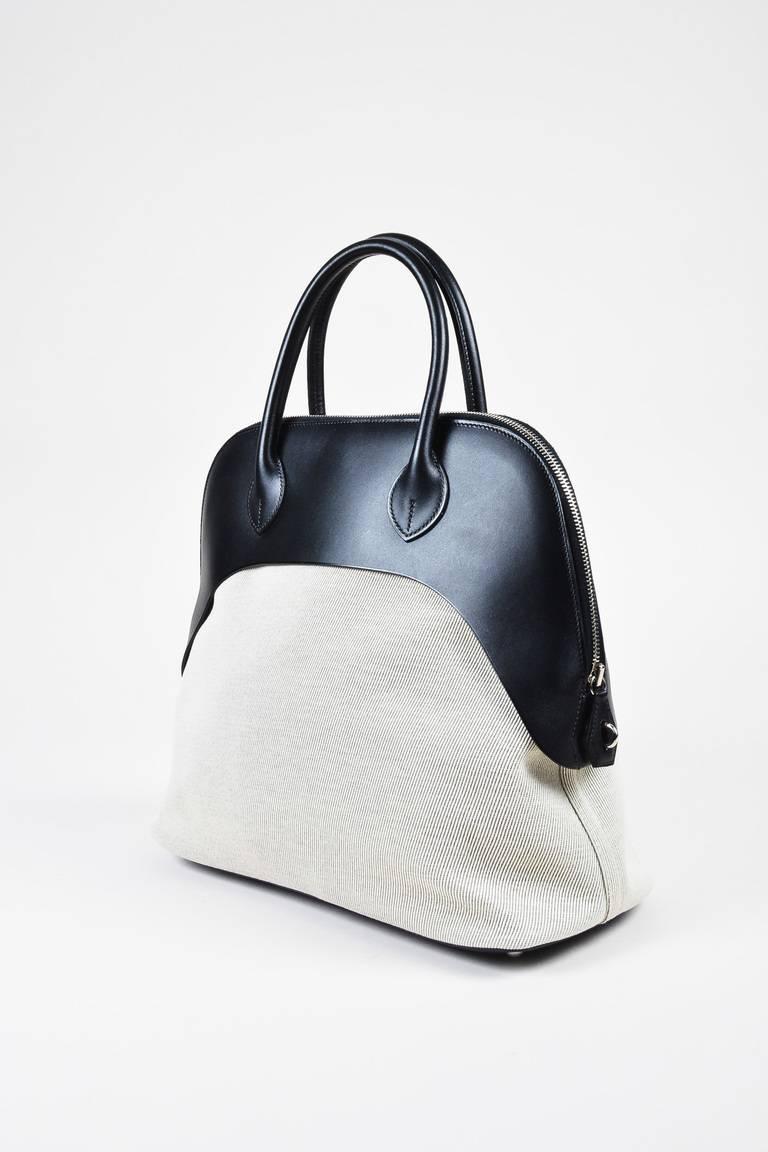 Color: Black,Silver,White,
Style: Bolide Paddock
Made In: France
Fabric Content: Vache Leather, Natural Toile Canvas

Item Specifics & Details: Comes in a box with a dust bag, lock, and key tassel. Released circa 2014. An iconic everyday carry-all,