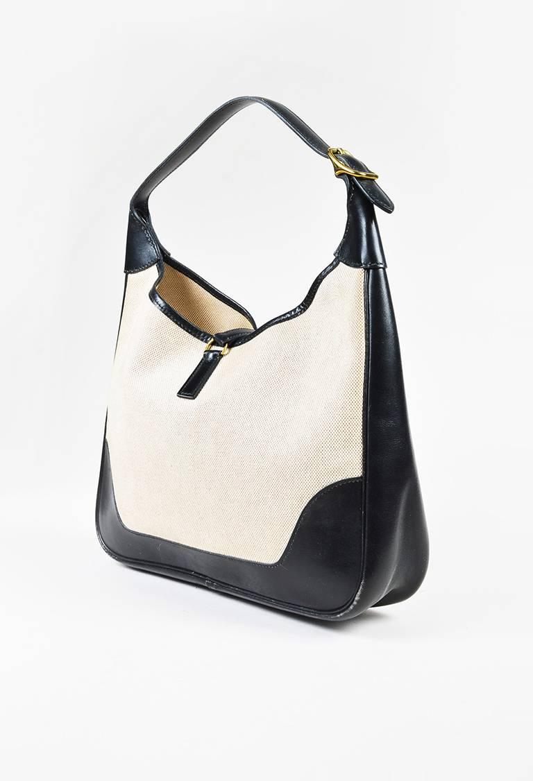Color: Beige,Black,Gold,
Style: Trim
Made In: France
Fabric Content: Box Calf Leather, Canvas

Item Specifics & Details: VINTAGE "Trim" style shoulder bag by Hermes circa 1995. Beige canvas and black box calf leather construction.