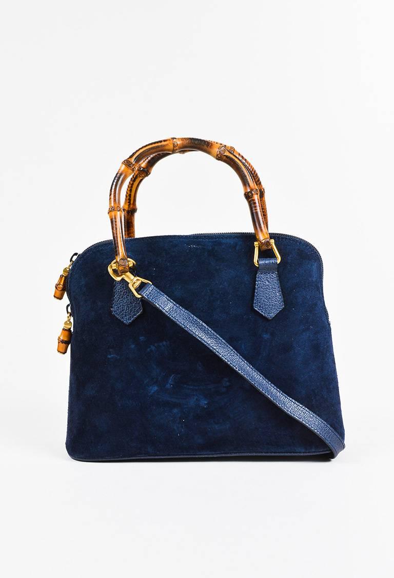Color: Blue, Brown 
Made In: Italy
Fabric Content: Exterior: Suede; Interior: Textile

Item Specifics & Details: Soft brushed suede construction. Gold-tone hardware. Structured bamboo handles. Removable flat strap; spring clasp closure. Studded