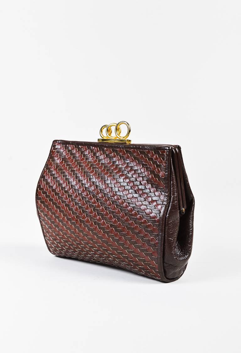 Color: Brown
Made In: Italy
Fabric Content: Exterior: Leather; Interior: Textile

Item Specifics & Details: Frame silhouette. Gold-tone hardware. Woven walnut and chocolate brown leather. Top three ring lock closure. Open interior. One interior zip