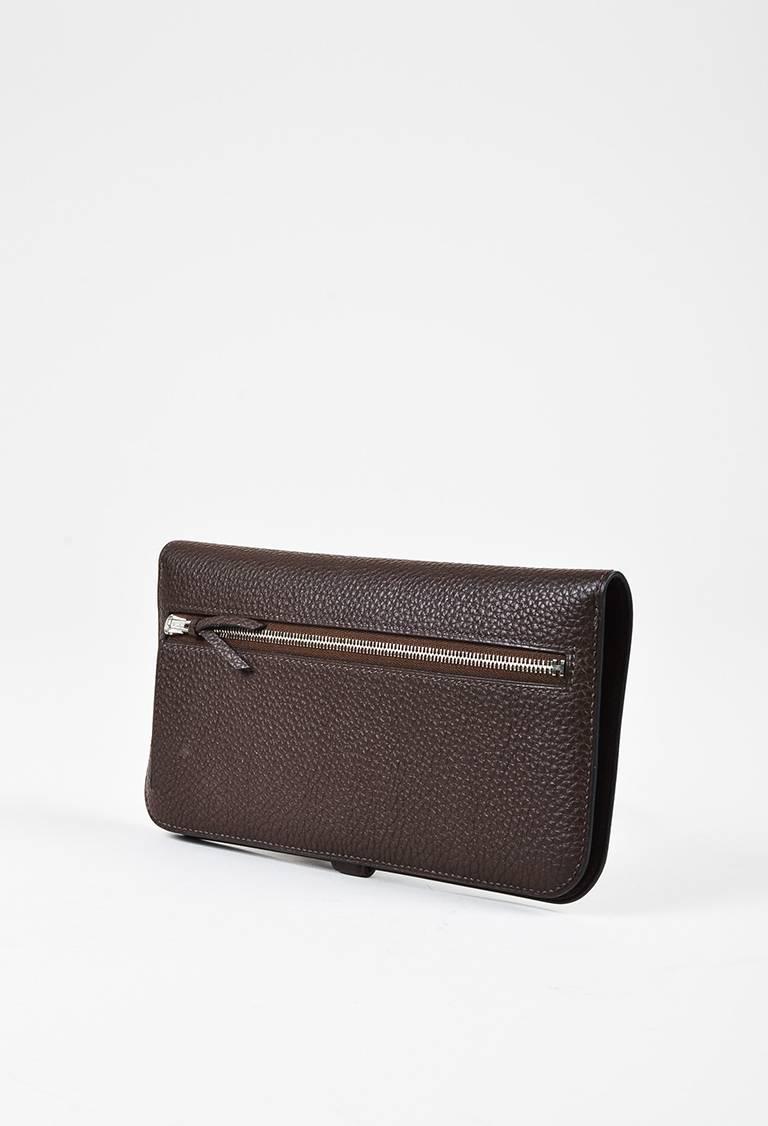 Color: Brown,Chocolate
Made In: France
Fabric Content: Togo Leather
Item Specifics & Details: Circa 2015. Supple Togo leather construction. Palladium hardware. Back zip compartment. Front flap with strap closure. Two bill compartments and eight card