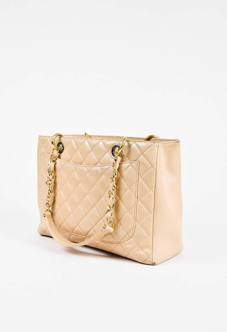 Color: Cream,Gold,
Style: Grand Shopping Tote
Made In: Italy
Fabric Content: Caviar Leather; Lining: Unknown
Item Specifics & Details: Circa 2012. "GST" classic tote bag by Chanel. Caviar leather construction. Features the brand's