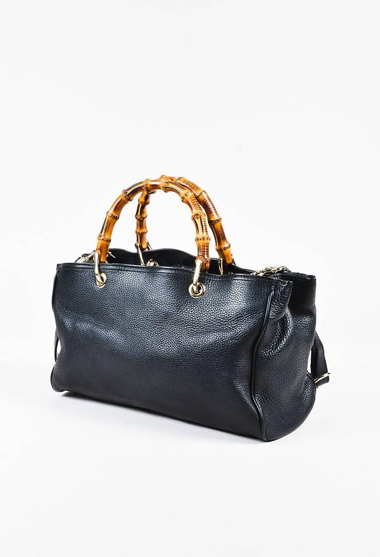 Color: Black
Style: Exclusive Bamboo Shopper
Made In: Italy
Fabric Content: Exterior: Leather; Interior: Canvas Textile

Item Specifics & Details: This spacious tote bag is great to carry throughout the day. Black pebbled leather 