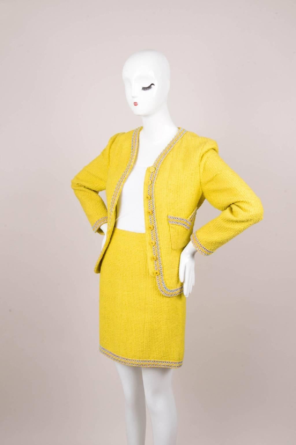 Size: 42
Color: Blue,Gold,Pink,White,Yellow,
Made In: France
Fabric Content: 58% Cotton, 39% Wool, 3% Nylon; Lining: 100% Silk

Item Specifics & Details: Make your day at the office a little brighter in this skirt suit by Chanel. The jacket is fully