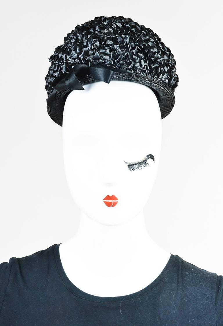 Color: Black,
Made In: Unknown
Fabric Content: Appears to be straw, but cannot confirm

Item Specifics & Details: Vintage hat featuring a round silhouette, layered weaving, and a satin bow at the side. Comes with box.

Opening Circumference: Approx.