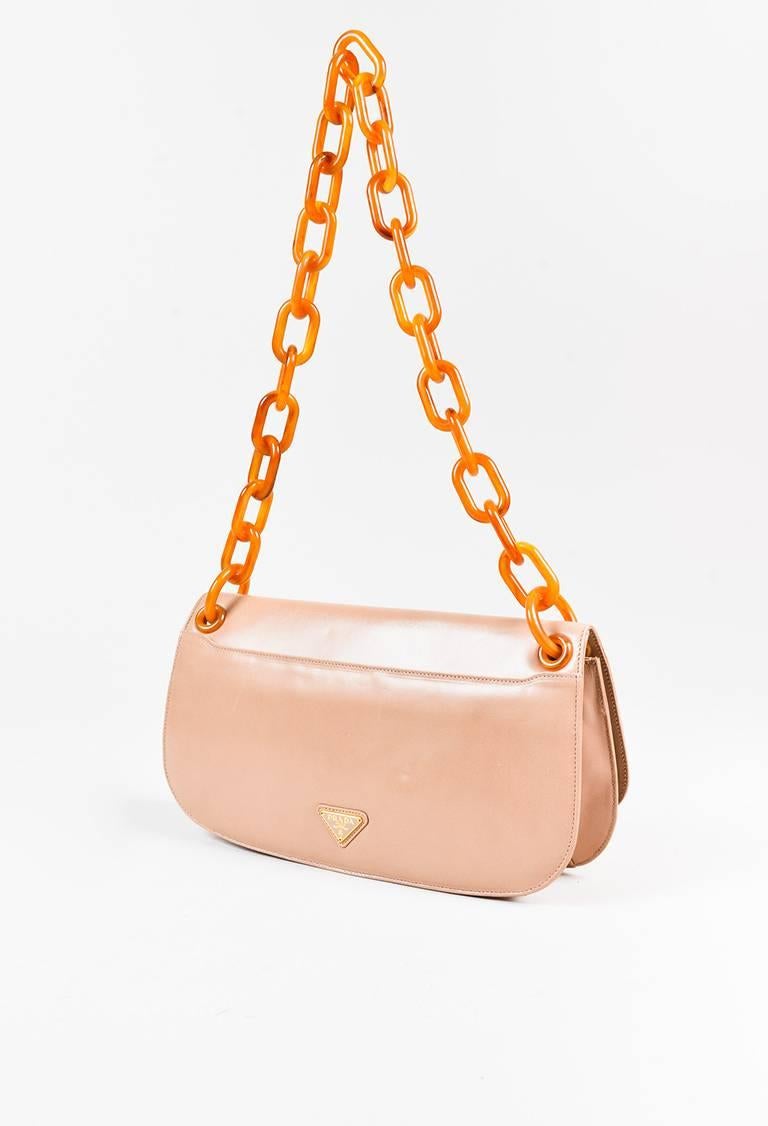 Color: Beige,"Cammeo"
Made In: Unknown
Fabric Content: Leather, Plastic

Item Specifics & Details: "Cammeo" beige leather and orange plastic chain link strap "Madra" shoulder bag from Prada circa 2011. Front flap