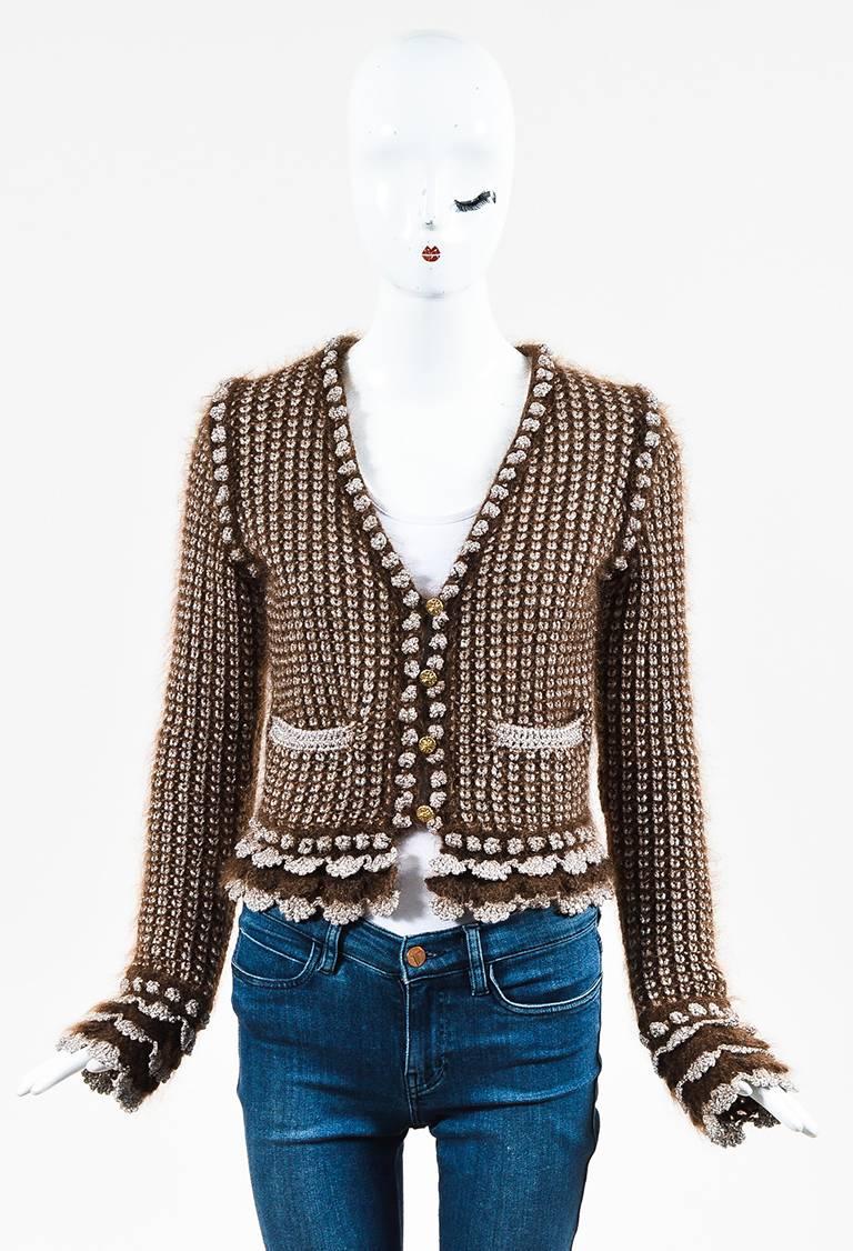 Size: 40 (FR)
Color: Brown,Metallic,
Made In: France
Fabric Content: Mohair, Nylon, Wool, Rayon, Polyester

Item Specifics & Details: Features a deep V-neck, long sleeves, a purl knit construction, scalloped metallic silver trim, two front pockets,