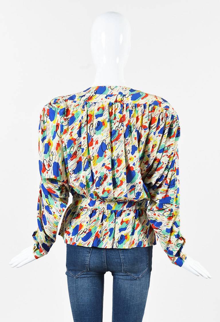 Size: 42 (FR)
Color: Multicolor,
Made In: France
Fabric Content: Silk

Item Specifics & Details: Features an allover multicolored abstract print with 'Coco' lettering, gold-tone 'CC' buttons down front, a peplum, and batwing sleeves.

Total Length: