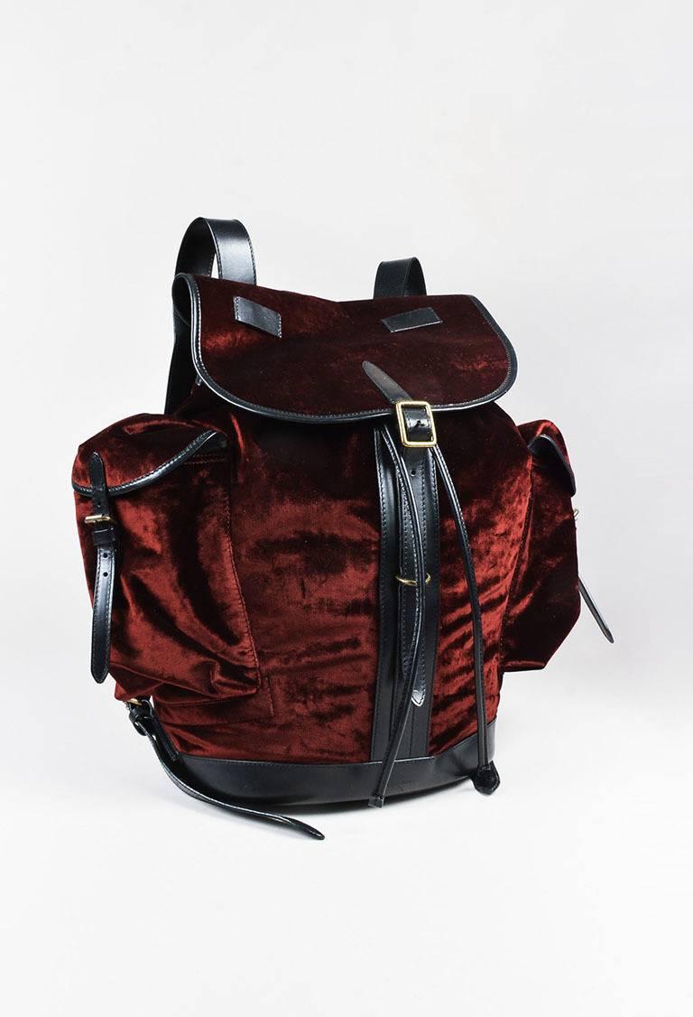 Color: Red,
Made In: India
Fabric Content: Polyester, Cotton, Leather, Viscose
Item Specifics & Details: Velvet exterior. Leather trimmings. Oxidized gold toned hardware. Top flat handle. Back adjustable shoulder straps. Side flap pockets with