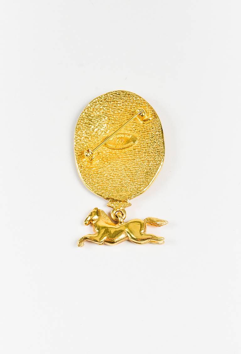 Gold-tone metal construction. Polished finish. 