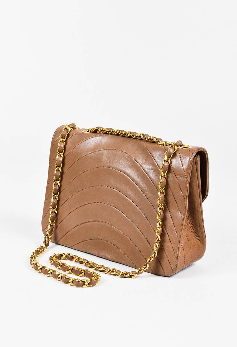 Leather construction. Gold-tone hardware. Curved quilting. Leather woven chain straps. Flap with 'CC' turn lock closure. Interior patch pocket. Leather lining.

Color: Brown,
Made in: France
Fabric Content: Exterior: Leather; Interior: