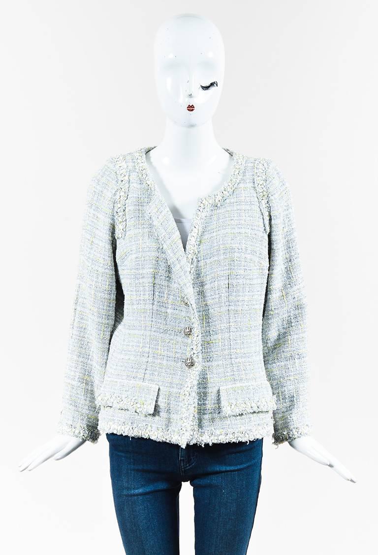 Cotton blend construction. Tweed weaving. Light metallic threading throughout. Fringe trimmings. Front flap pockets. Long sleeves. Padded shoulders. Front button closure. Lined.

Size: 42 (FR)
Made in: France
Color: Blue, Grey
Content: Cotton, Wool,