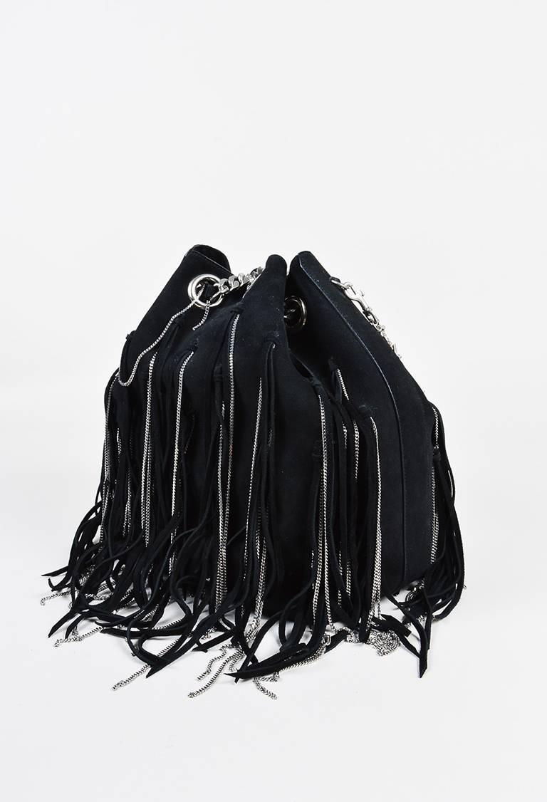 Black suede hobo bag from Saint Laurent. Suede and thin silver-tone chain link fringe detailing. Two silver-tone chain link handles for wear. Five silver-tone bag feet. Interior lining features a snap pocket and two open pockets. Style/control #: