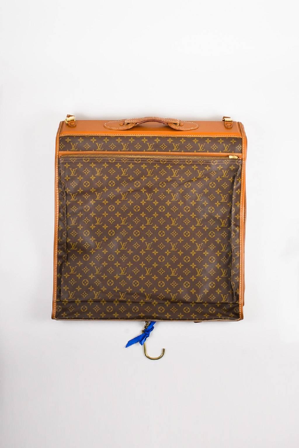 From the French Luggage Company collaboration. A piece of iconography, this luxurious garment bag from the 1970s/1980s is constructed of signature coated canvas with leather trimming. Detailed with iconic monogramming, this must-have piece of