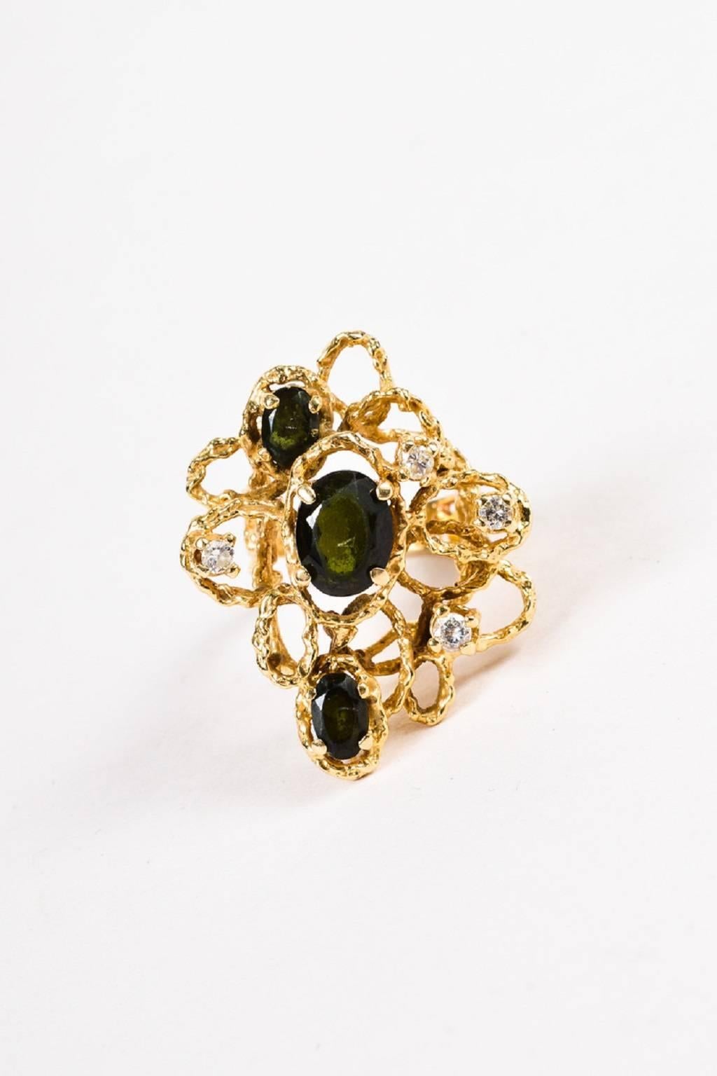 Size: 5.5
Color: Gold,Green,
Made In: Unknown.
Fabric Content: 14K Yellow Gold, Green Tourmaline, Diamond
Item Specifics & Details: Unique cocktail ring that oozes vintage elegance. 14K yellow gold construction. Polished finish. Intricate woven