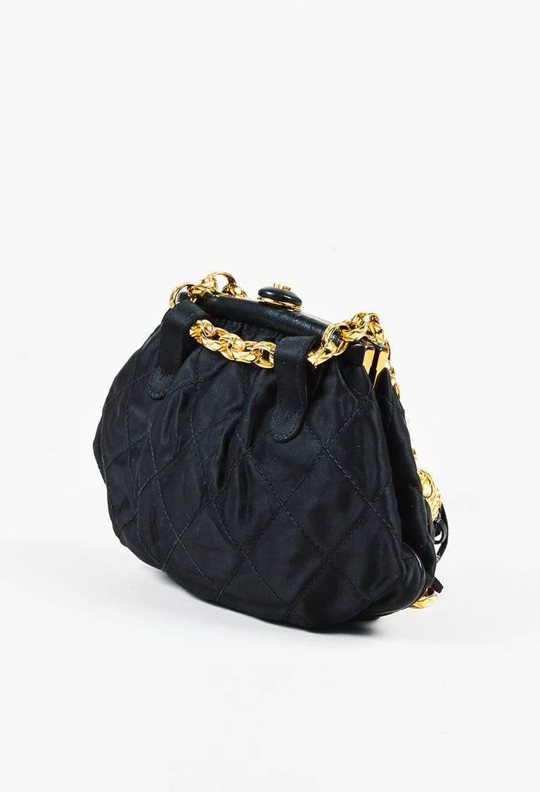 Black satin quilted belt bag from Chanel circa 1989-1991. Leather trim. Top frame with a 'CC' closure. Gold-tone chain link strap with a leather fringe tassel. Red leather interior features a zip pocket. Serial #: 1722654.

Made in: Italy
Color: