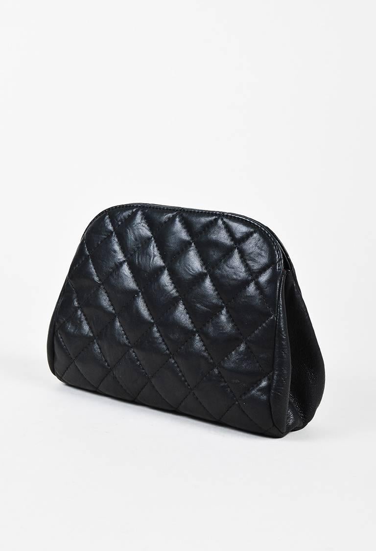 Chanel "Leo" clutch featuring a supple lambskin construction, iconic quilting, a lion relief detail at front with a 'CC' printed pearl accent, and a hidden snap closure at the interior. Two open compartments. Released circa spring 2011.