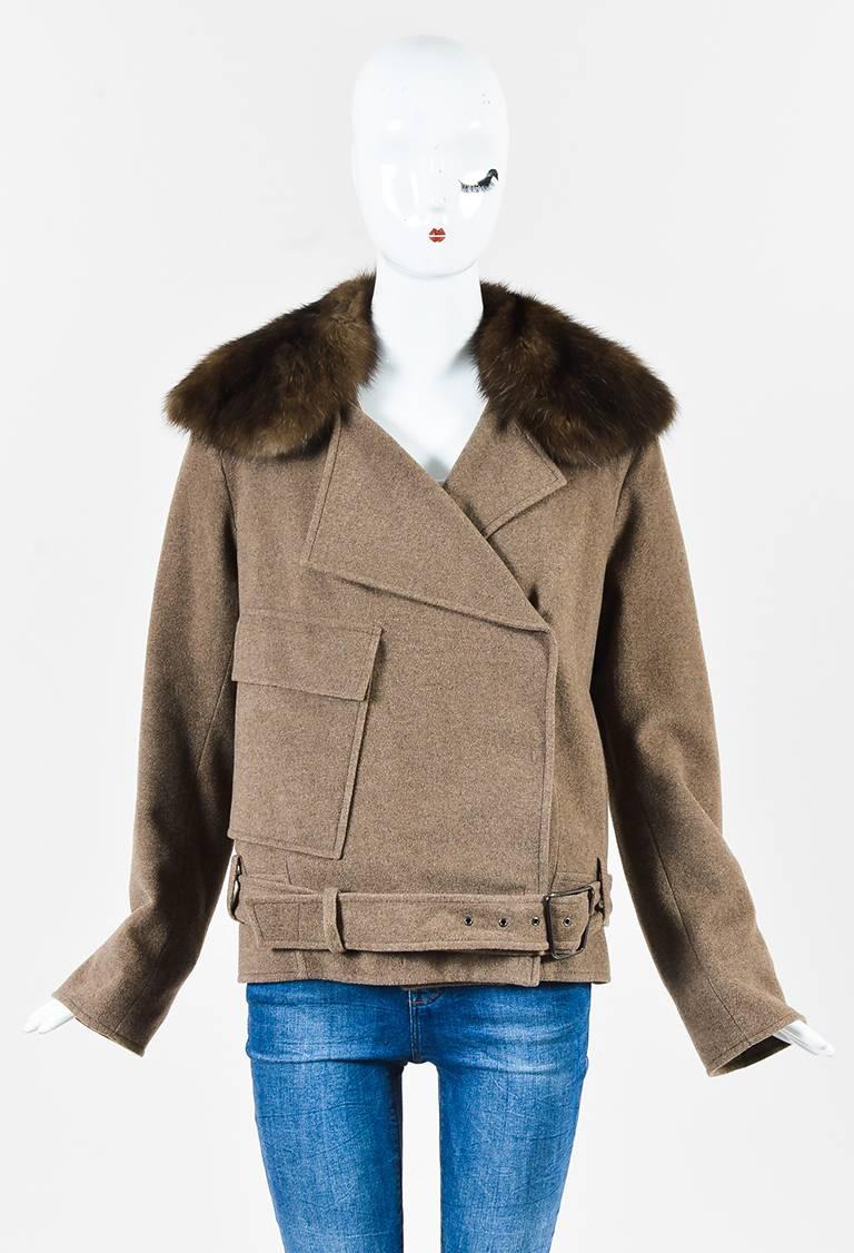 Light brown cashmere double breasted coat from Akris features a dark brown Russian sable collar. Lapels. Concealed snaps down the front for closure. Side pockets. A flap pocket on the right side on the front. Comes with an adjustable belt with a