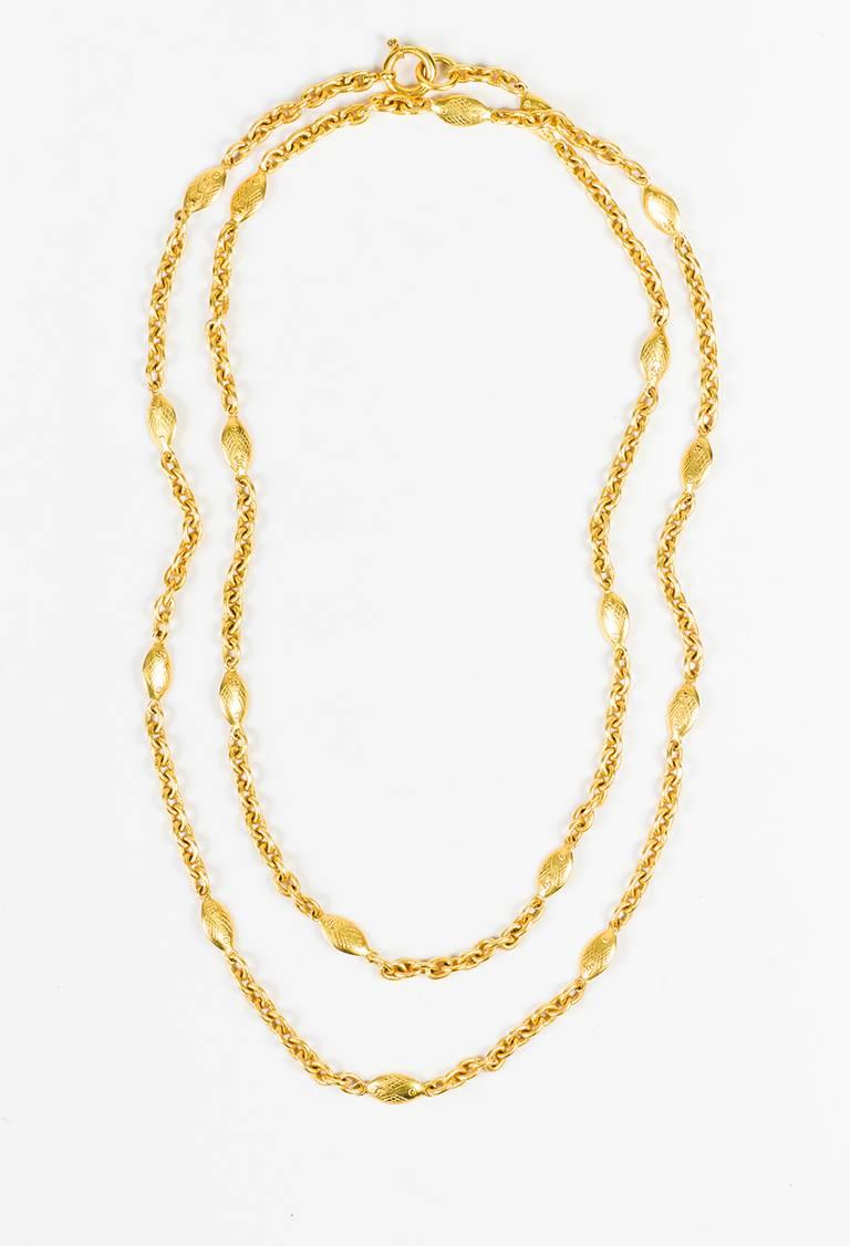 Vintage single strand necklace featuring a gold-tone metal construction, fish stations with 'CC' details, and a spring ring clasp. From the spring 1994 collection. Can be worn single or doubled to suit your look.

Made in: Unknown
Color: