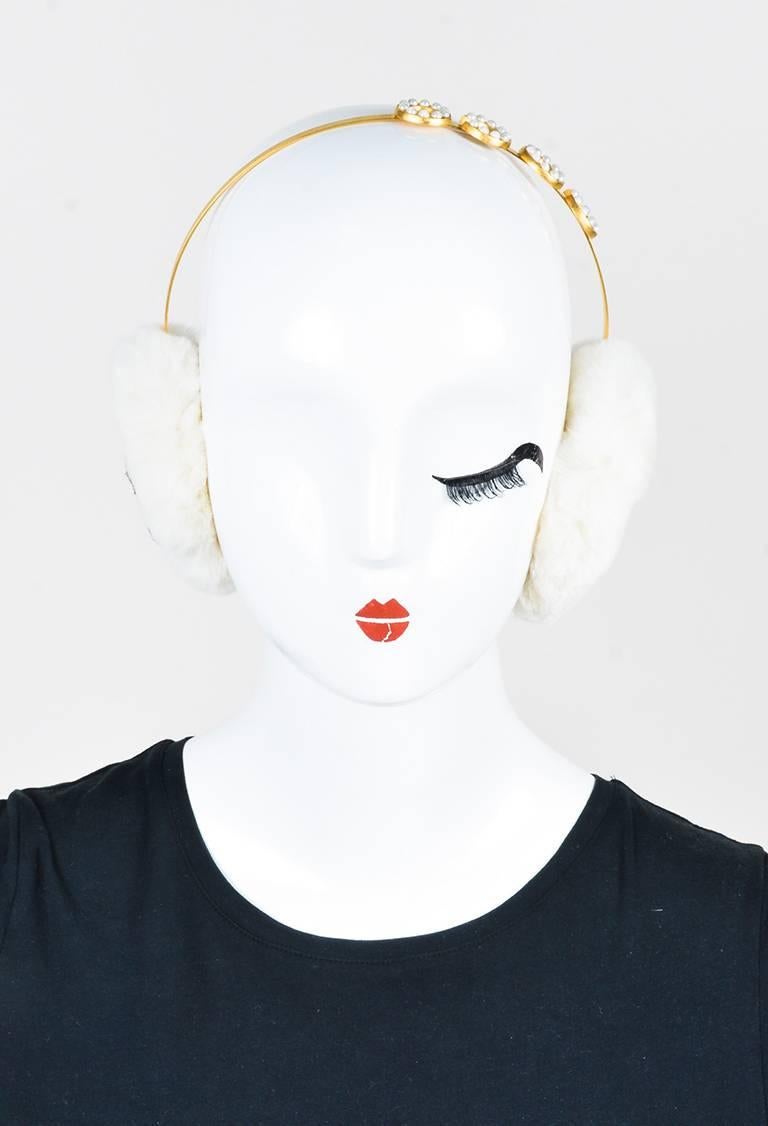 Stay chic in winter with this pair of earmuffs from Chanel. Gold-tone metal band with faux pearl embellishments. Ear padding is constructed out of genuine sheared rabbit fur and features a black interlocking 'CC' logo. Comes with: Dust Bag

Color: