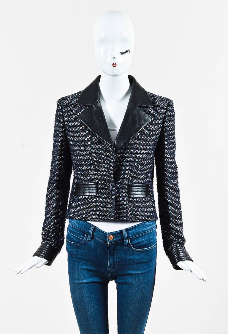Chanel jacket featuring a speckled lambskin leather trim, logo-buttoned front, two front pockets, and quilted cuffs. Lined. From the autumn 2002 collection.

Size: 38 (FR)
Color: Black,Blue,Gold,Metallic,Silver,
Made in: France
Fabric Content: