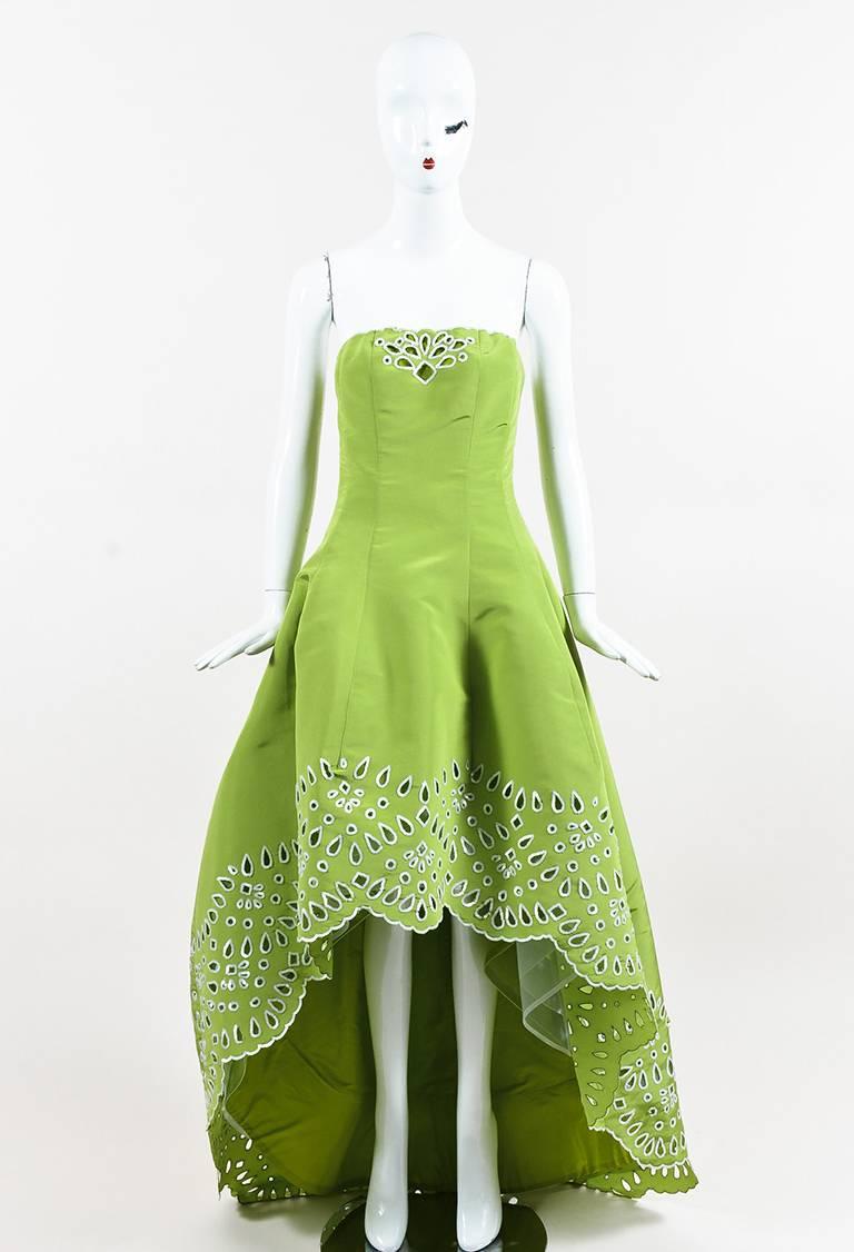 Silk Oscar de la Renta gown featuring a strapless bodice, boning, sequined eyelet detailing, a high-low hem, scalloped edges, and a center back zip closure. Lined. Released circa spring 2015. Comes with: Brand Tags

Size: 2 (US)
Color: Green,
Made