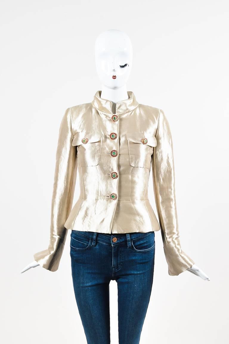 Retails at $9,500. From the Fall 2012 collection. Gold tailored jacket from Chanel. Metallic silk construction. Designed with red and green gropoix button closures. Patch pockets at chest. Band collar. Long sleeves. Lined.

Size: 36
Color: