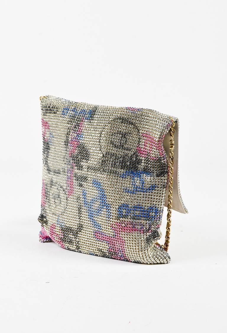 This Chanel bag puts a sparkling twist on the typical graffiti look. Multicolored crystal embellishment throughout exterior with signature logo detail. Gold-tone hardware. Attached leather woven chain strap. Front flap Open interior. Satin