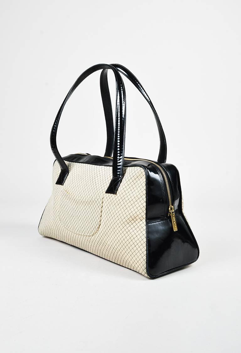 Chanel bowler bag featuring quilted knit front and back panels, an interlocking 'CC' stitch at front, flat handles, gold-tone hardware, a footed seat, and a zip-around closure. Released circa 2002-2003. Serial #: 7350712.

Size: N/A
Color: