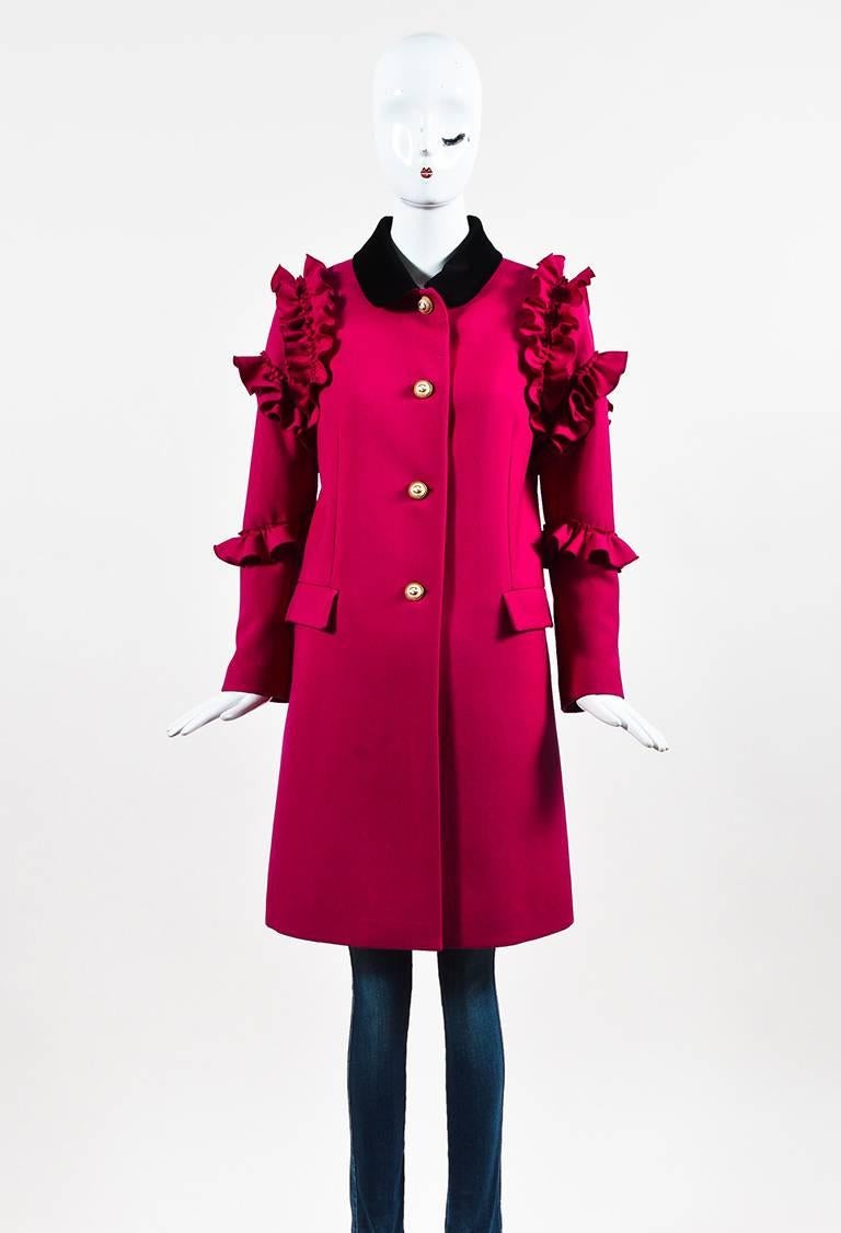 A feminine twist on the typical overcoat from the Resort 2017 collection. Rich raspberry pink wool construction. Plush velvet collar. Ruffle trimmings. Faux pearl 'GG' buttons with gold-tone trim. Long sleeves. Side flap pockets. Front button