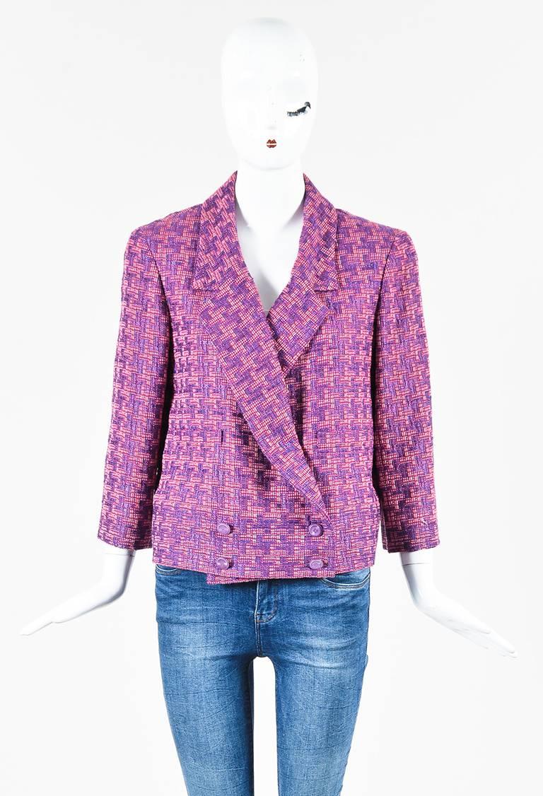 Pink and purple wool blend tweed patterned double breasted blazer jacket from Chanel circa Spring 2001. Collar and lapels. Shoulder pads. Sleeves hit slightly above the wrists. Deep v-cut neckline. Two faux open pockets on the lower front. Lined.