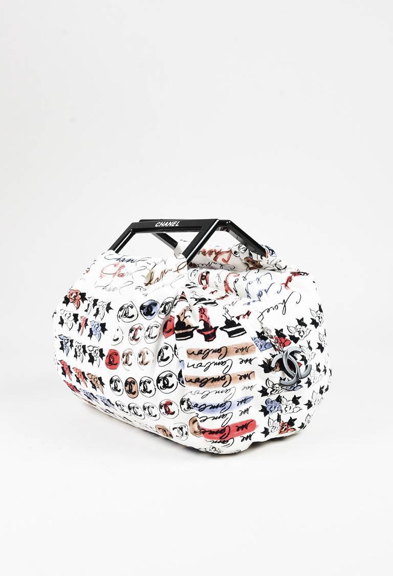 Unique summer bag from Chanel circa 2005-2006. Plush velvet exterior. Script logo graphic prints throughout. Glossy black frame handles. Silver-tone hardware. Zip closure. Interior zip pocket. Textile lining. Serial #: 10520004. Comes with: Brand