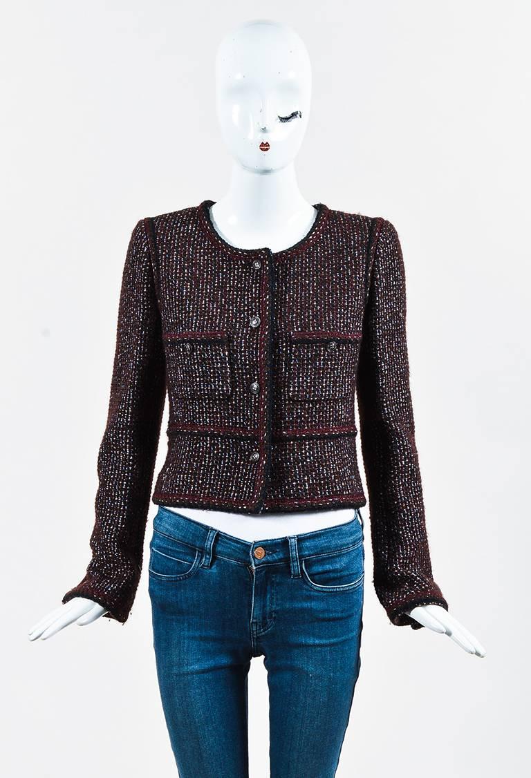 Sophisticated Chanel tweed jacket from the 2002 collection. Wool construction. Woven metallic accents. Long sleeves. Front patch pockets. Padded shoulders. Front button closure. Lined.

Size: 40 (FR)
Color: Brown,Purple,
Made in: France
Fabric