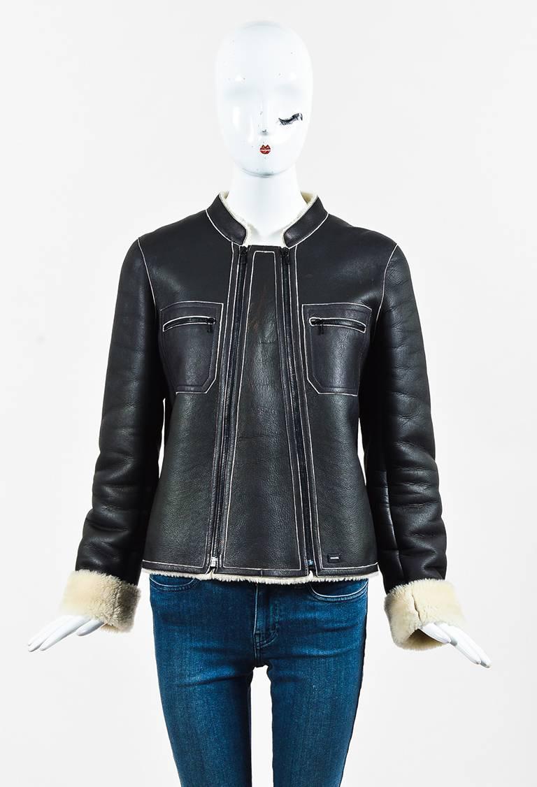 This moto Chanel shearling jacket is the perfect addition to your fall wardrobe. From the fall 2004 collection. Soft lambskin construction. Soft leather exterior. Plush fur lining. Long sleeves. Front zip pockets. Front double zip closure.

Size: 40