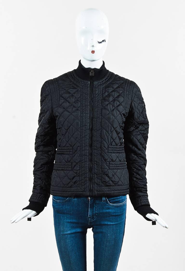 Stay stylish on the slope in this Chanel Identification puffer jacket from fall 2005 collection. Diamond quilted stitching throughout. Wool rib trimmings. Front welt pockets. Long sleeves. Front zip closure. Lined.

Size: 42 (FR)
Color: Black,
Made
