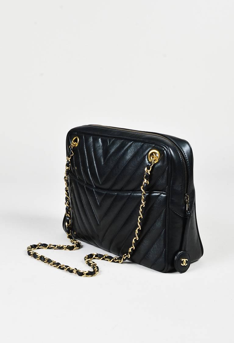 Channel Chanel vintage style with this chevron quilted shoulder bag. Circa 1986-1988. Soft lambskin leather construction. Gold-tone hardware. Leather woven chain straps. Front and back flat compartments. Top zip closure. Two interior zip pockets and