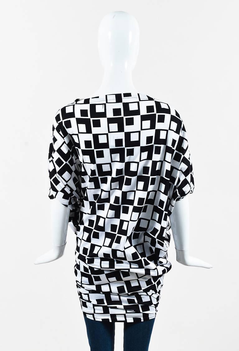 Junya Watanabe Comme des Garcons tunic top featuring a bi-color geometric print, twisted and open details, and a boat neck.

Size: Medium
Color: Black,White,
Made in: Japan
Fabric Content: Appears to be cotton, but cannot confirm
Condition: