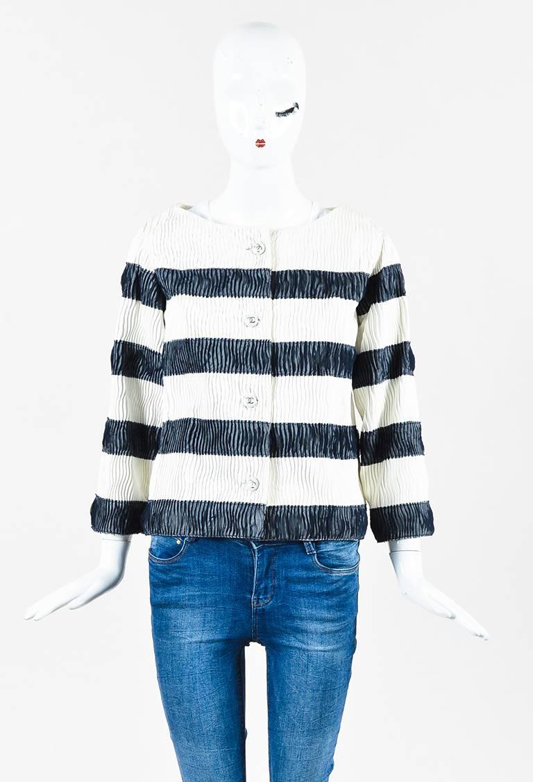 Chanel jacket featuring a pleated lambskin construction, enameled 'CC' buttons down front, pleated sheer silk detailing, three-quarter length sleeves, a boat neck, and side pockets. Lined.

Size: Unknown
Color: Blue,White,
Made in: Unknown
Fabric