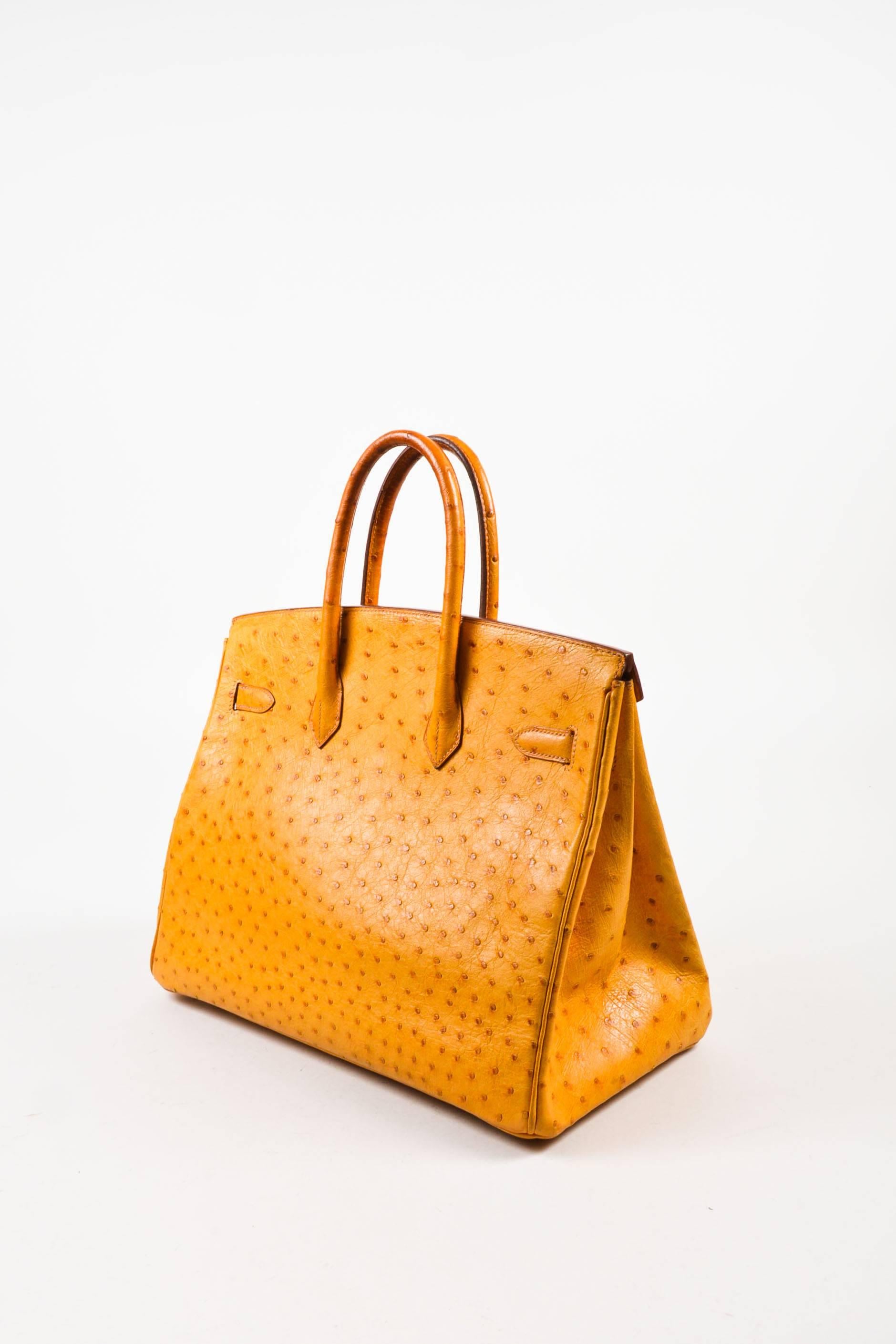 Comes in box and dust bag. This luxurious 35cm size Birkin handbag is a warm orange-tan 
