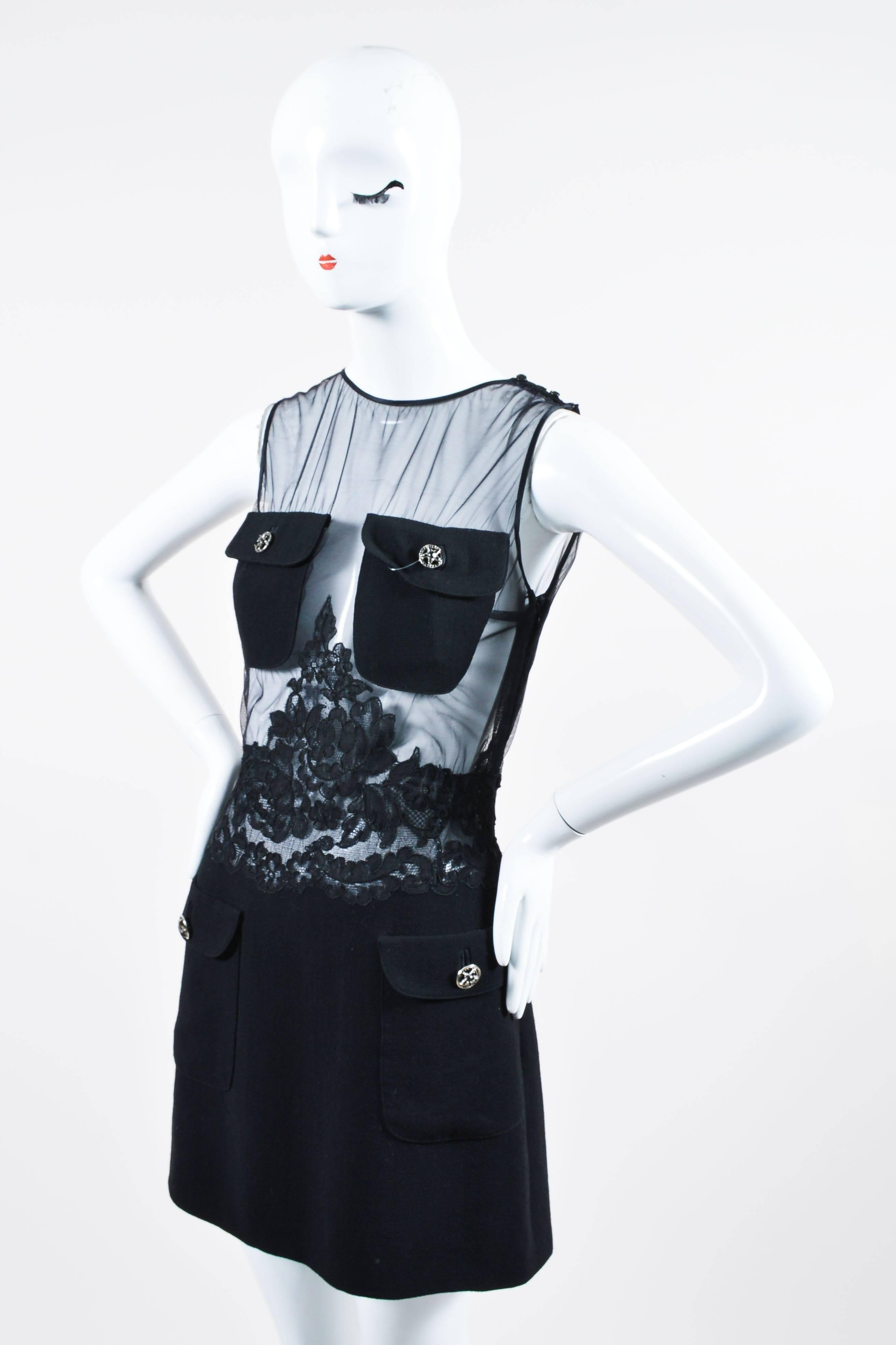 Retails at $2150. Vintage item, with original tags from the Istante line circa 1980's. Edgy sheath dress. Black sheer mesh bodice with lace trim around waist. Woven wool blend skirt. Sleeveless. Rounded neckline. Knee length hem. Flap pockets with