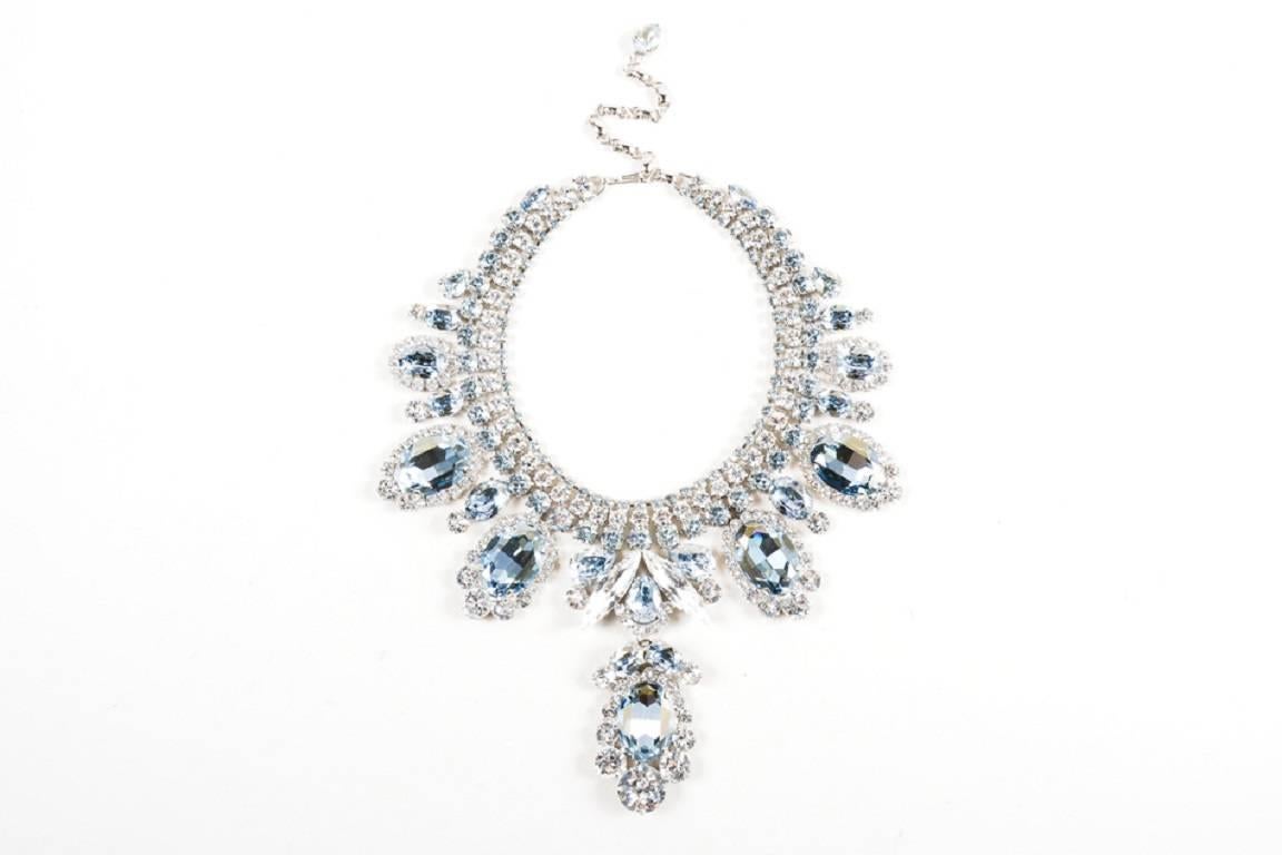 Retails at $2575. Eye catching statement bib necklace. Silver tone metal setting. Clear circular glass rhinestones throughout. Oval, oversized blue glass rhinestone pendants. Extender for adjustable sizing. Hook closure.

Additional