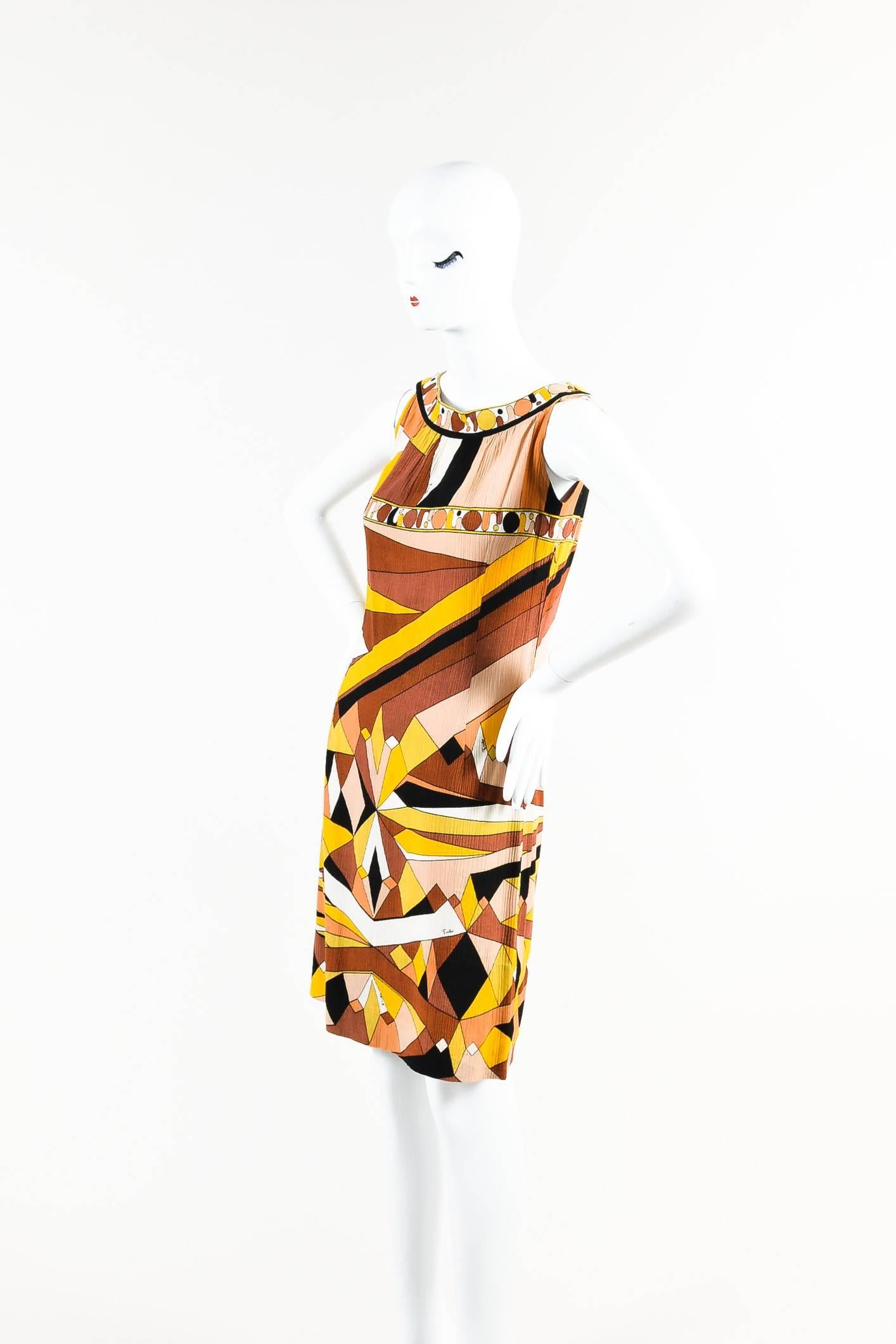 This vintage Emilio Pucci dress was gifted from Pucci himself and features a textured crepe cotton in a sleeveless, shift style. Boat neckline. Button details at tops of shoulders/straps. Signature abstract Pucci pattern throughout. Hidden side
