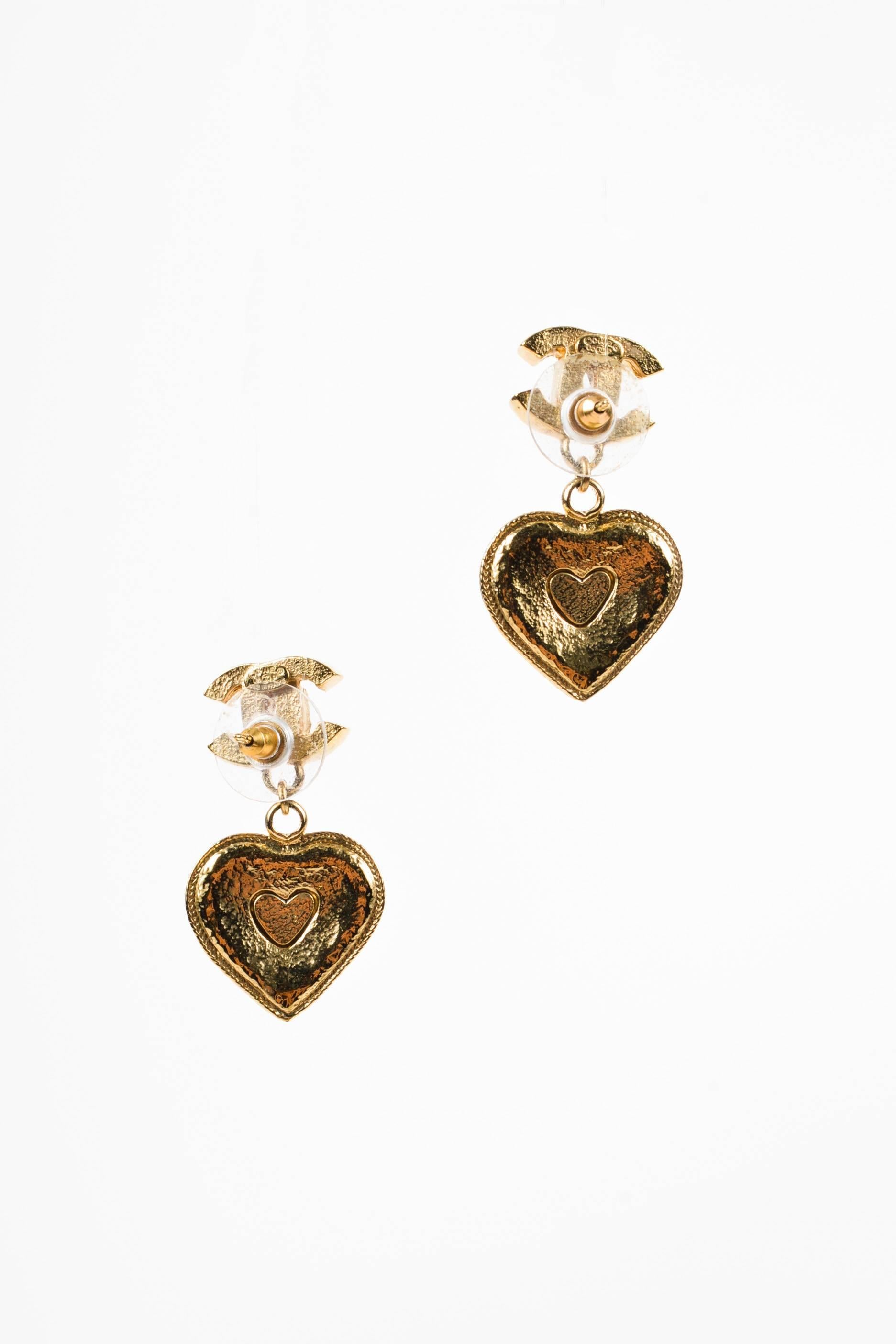 From the Spring 2005 collection, these stunning earrings are dripping in timeless elegance and glitz with their iconic interlocking 'CC' stud, crystal encrusted heart detail, and a four leaf clover with signature Gripoix stones. Circle post back.