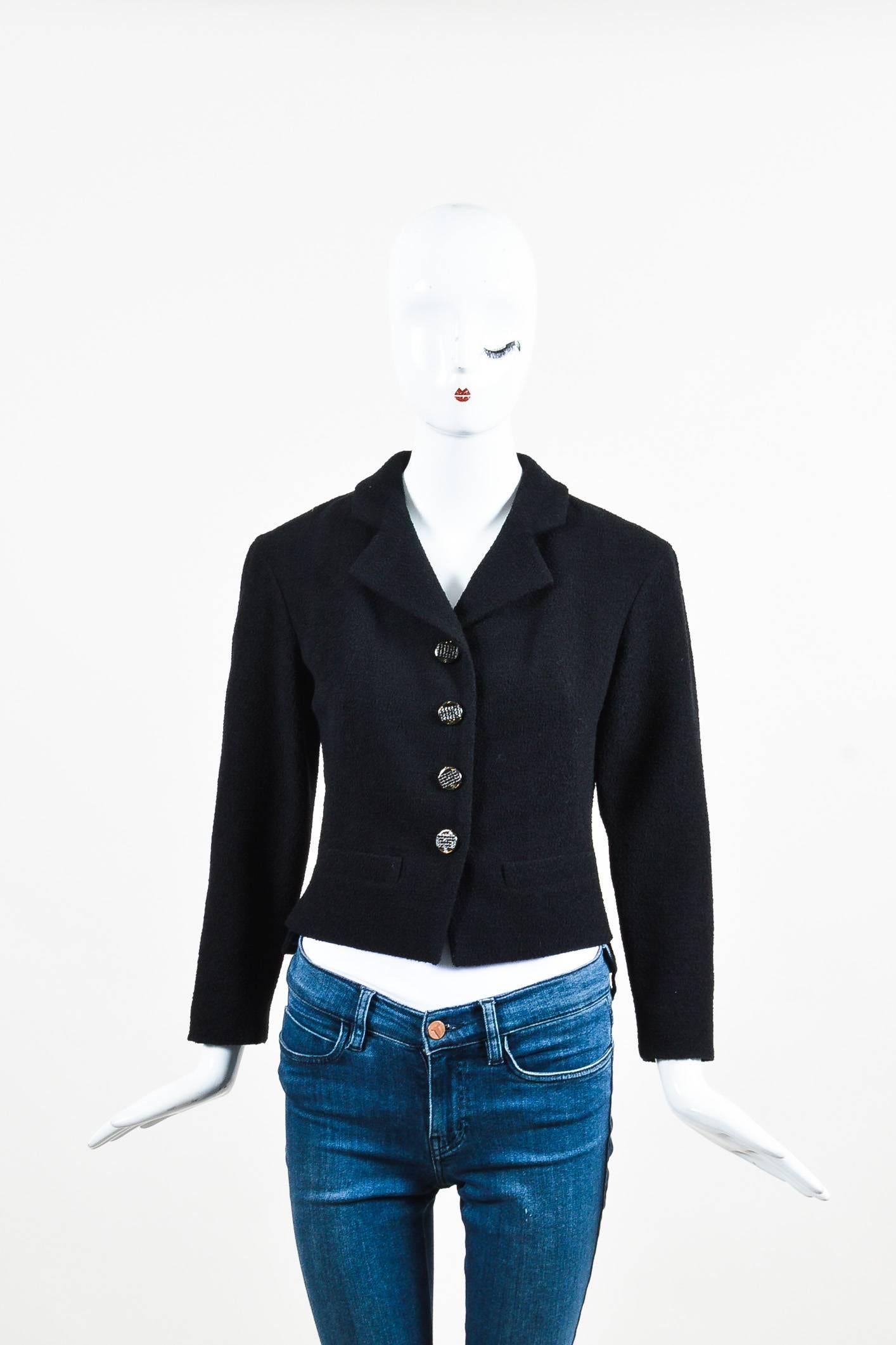 Fabric Content: Wool, Nylon, Silk; Lining: Silk

Item Specifics & Details: Chic and classic Chanel jacket in a black wool blend. Textural, boucle material with a weighted chain hem. Gunmetal, rhinestone buttons at the front with glitter accents